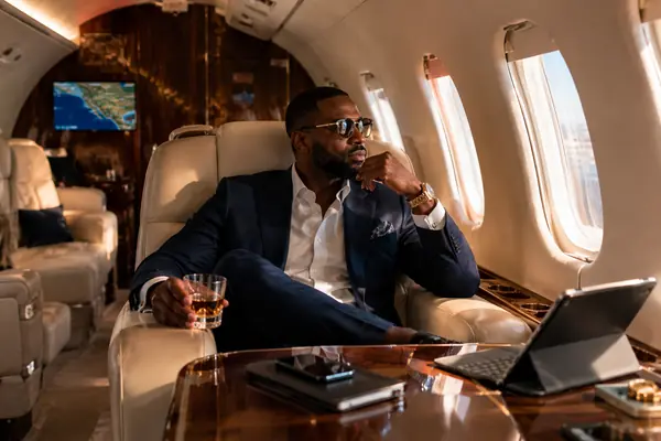 Luxury private jet interior, passenger relaxing in-flight
