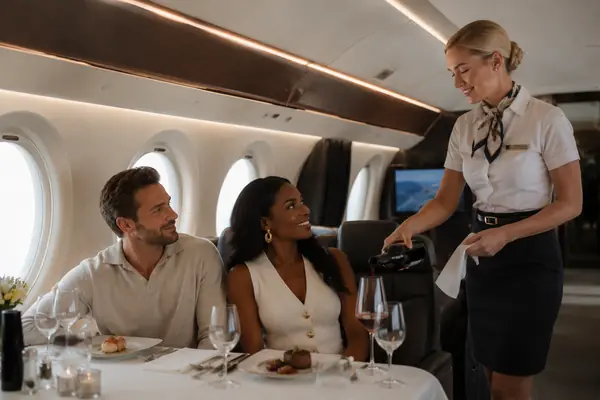 Cabin crew beverage service aboard private jet
